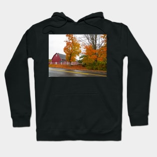 Traditional American style red barn from passing highway in fall with bright foliage in rural USA Hoodie